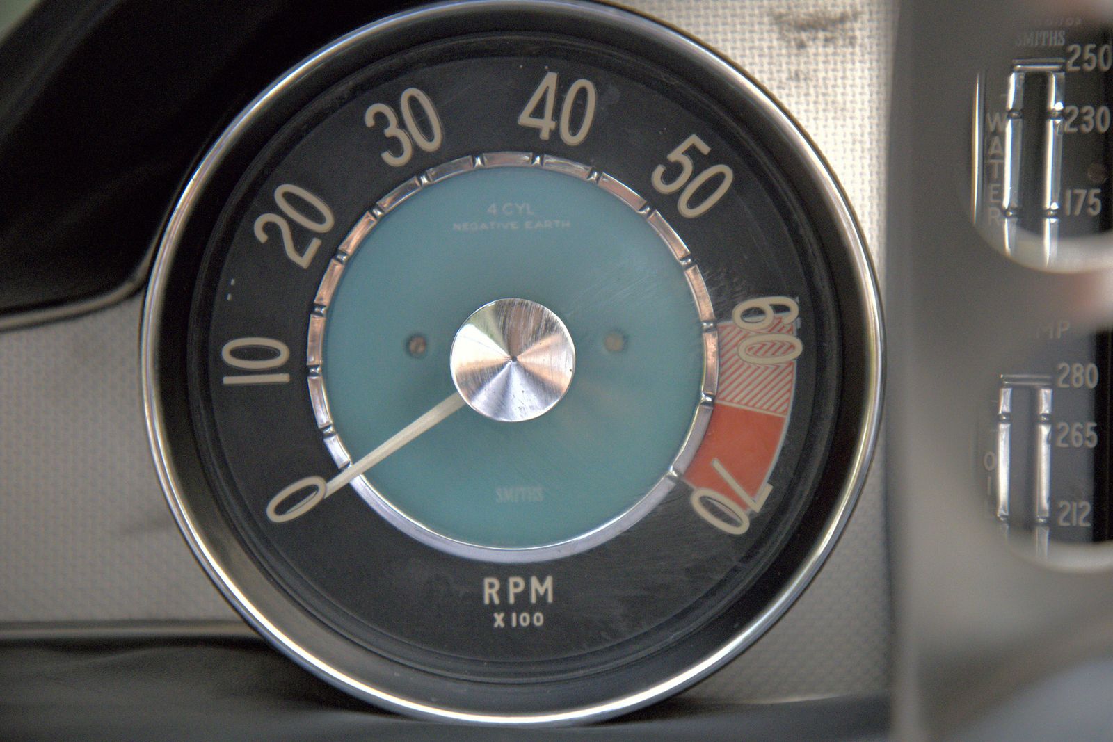 Close-up of a Smiths rev counter in a classic car dashboard